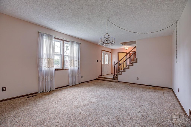 2974 Acer Ct, Ross Twp, OH 45013 - carpeted spare room featuring a chandelier, stairs, and a textured ceiling