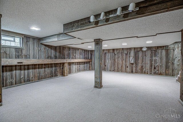 2974 Acer Ct, Ross Twp, OH 45013 - basement featuring wood walls, a textured ceiling, and carpet