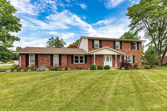 2974 Acer Ct, Ross Twp, OH 45013 - traditional-style home featuring brick siding, a front lawn, and a chimney