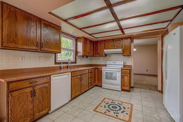 2974 Acer Ct, Ross Twp, OH 45013 - kitchen featuring white appliances, under cabinet range hood, brown cabinetry, tasteful backsplash, and light tile patterned floors