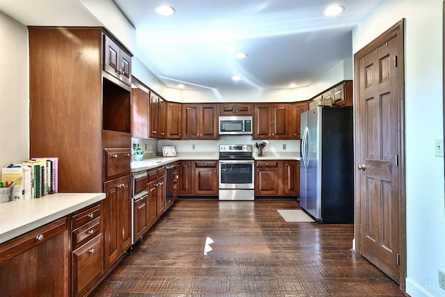 254 Compton Rd, Wyoming, OH 45215 - kitchen featuring stainless steel appliances, dark wood finished floors, light countertops, recessed lighting, and dark brown cabinets