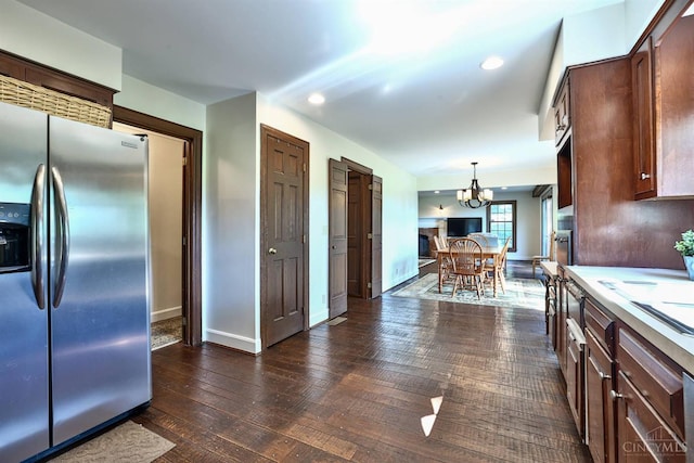 254 Compton Rd, Wyoming, OH 45215 - kitchen with stainless steel refrigerator with ice dispenser, light countertops, a chandelier, pendant lighting, and dark wood-style floors