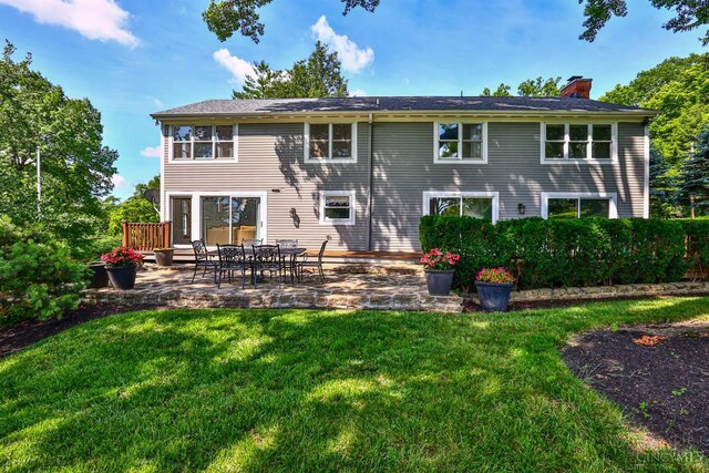 254 Compton Rd, Wyoming, OH 45215 - rear view of house with a chimney, a lawn, and a patio