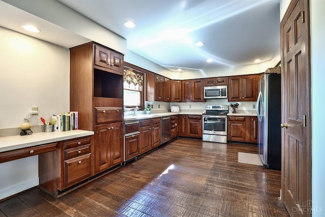 254 Compton Rd, Wyoming, OH 45215 - kitchen with stainless steel appliances, light countertops, dark wood-style floors, recessed lighting, and dark brown cabinets