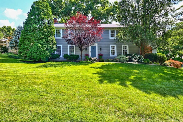 254 Compton Rd, Wyoming, OH 45215 - colonial house featuring a front yard and a chimney
