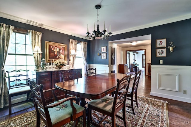 254 Compton Rd, Wyoming, OH 45215 - dining room featuring a chandelier, wainscoting, crown molding, dark wood-type flooring, and a decorative wall