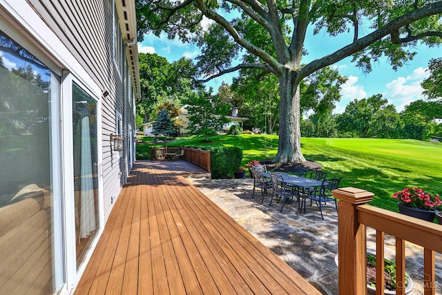 254 Compton Rd, Wyoming, OH 45215 - wooden deck featuring a lawn, a patio, outdoor dining space, and view of scattered trees