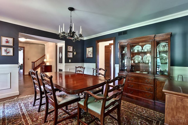 254 Compton Rd, Wyoming, OH 45215 - dining room featuring a chandelier, wainscoting, ornamental molding, stairs, and wood finished floors