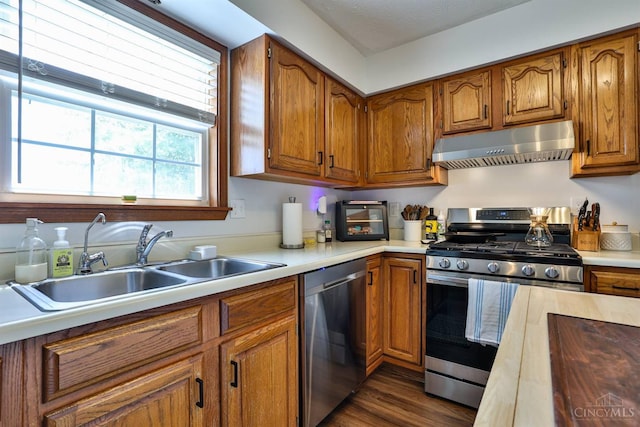 2487 Haddock Dr, Lawrenceburg, IN 47025 - kitchen with stainless steel appliances, under cabinet range hood, brown cabinets, and light countertops