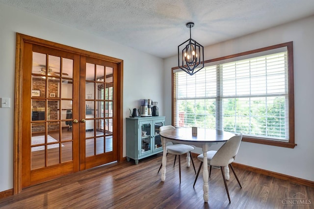 2487 Haddock Dr, Lawrenceburg, IN 47025 - dining room featuring french doors, healthy amount of natural light, dark wood-style flooring, a chandelier, and a textured ceiling