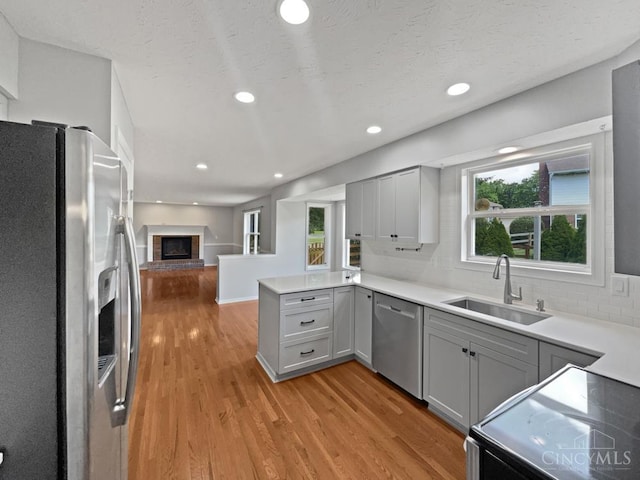 6336 Lansing Ct, Liberty Twp, OH 45011 - kitchen featuring appliances with stainless steel finishes, gray cabinets, open floor plan, light wood-style flooring, and recessed lighting