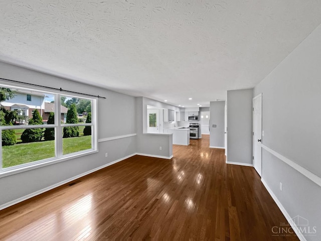 6336 Lansing Ct, Liberty Twp, OH 45011 - unfurnished living room featuring dark wood-style flooring, a textured ceiling, and recessed lighting