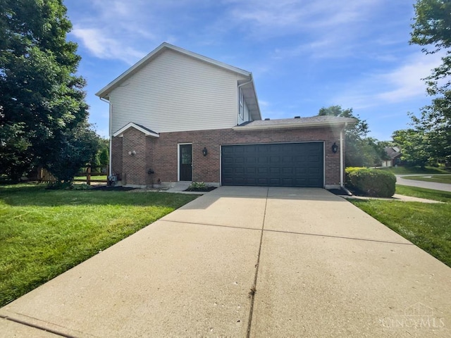 6336 Lansing Ct, Liberty Twp, OH 45011 - view of property exterior featuring a yard, concrete driveway, and brick siding