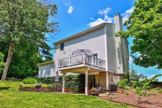8050 Redhaven Ct, Colerain Twp, OH 45247 - back of property with a chimney, a lawn, and a deck