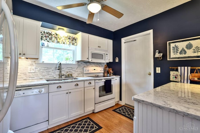 8050 Redhaven Ct, Colerain Twp, OH 45247 - kitchen with white appliances, tasteful backsplash, white cabinets, light wood finished floors, and a ceiling fan