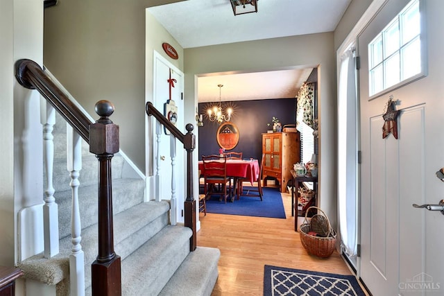 8050 Redhaven Ct, Colerain Twp, OH 45247 - entrance foyer featuring a chandelier, stairs, and light wood-style flooring