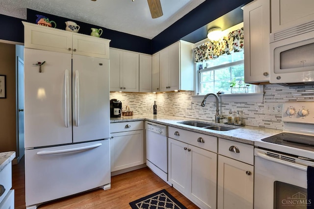 8050 Redhaven Ct, Colerain Twp, OH 45247 - kitchen featuring white appliances, white cabinetry, decorative backsplash, light wood-type flooring, and light stone counters
