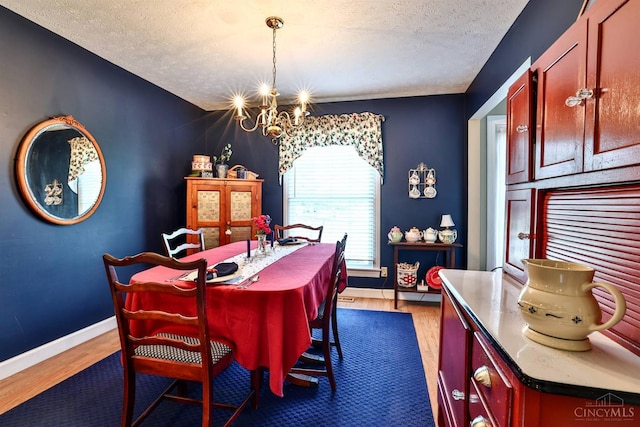 8050 Redhaven Ct, Colerain Twp, OH 45247 - dining space featuring a chandelier, a textured ceiling, and wood finished floors