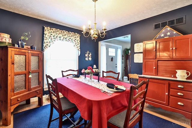 8050 Redhaven Ct, Colerain Twp, OH 45247 - dining area with a chandelier, dark wood-type flooring, and a textured ceiling