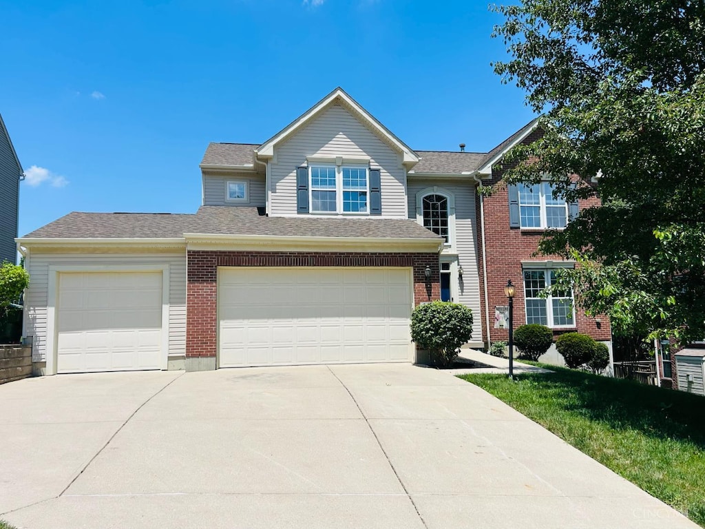 544 Mitchell Way Ct, Delhi Twp, OH 45238 - view of front of house with concrete driveway, brick siding, and a garage