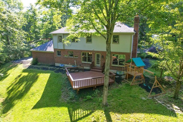 7029 Stonington Rd, Anderson Twp, OH 45230 - rear view of property with a lawn, a chimney, a wooden deck, a playground, and a shingled roof