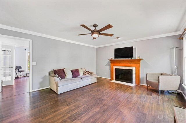 7029 Stonington Rd, Anderson Twp, OH 45230 - living room with wood finished floors, a ceiling fan, a tile fireplace, and ornamental molding