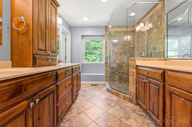 7029 Stonington Rd, Anderson Twp, OH 45230 - bathroom featuring double vanity, a stall shower, and recessed lighting