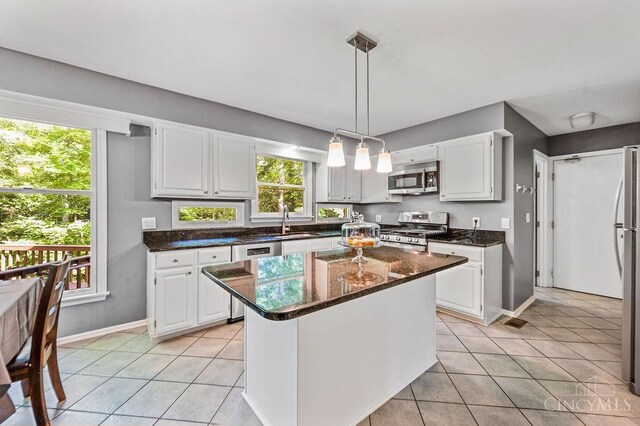 7029 Stonington Rd, Anderson Twp, OH 45230 - kitchen featuring appliances with stainless steel finishes, light tile patterned floors, and white cabinetry