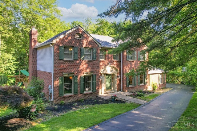 7029 Stonington Rd, Anderson Twp, OH 45230 - view of front of house with a chimney, brick siding, and a front lawn