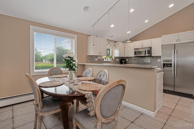 854 Nordyke Rd, Anderson Twp, OH 45255 - dining room with light tile patterned floors, recessed lighting, vaulted ceiling, and a baseboard radiator