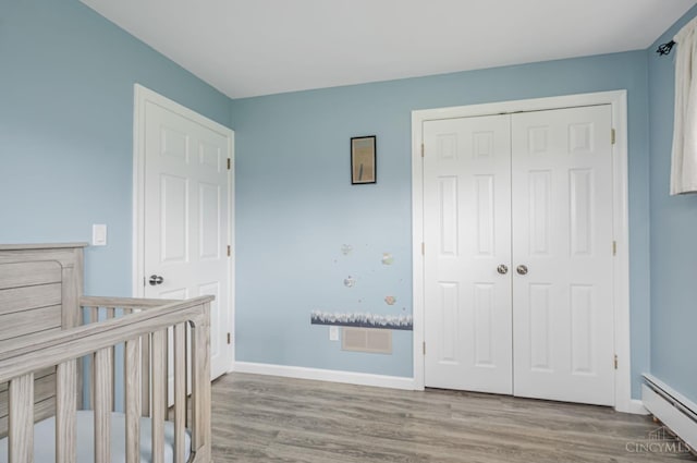 854 Nordyke Rd, Anderson Twp, OH 45255 - unfurnished bedroom with a baseboard radiator, wood finished floors, and a closet