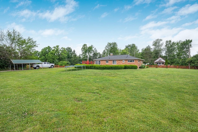 854 Nordyke Rd, Anderson Twp, OH 45255 - view of green lawn featuring a trampoline and a carport
