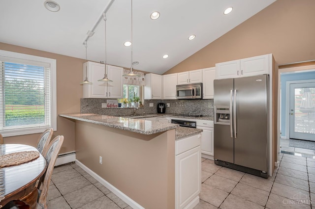 854 Nordyke Rd, Anderson Twp, OH 45255 - kitchen with stainless steel appliances, a peninsula, decorative backsplash, vaulted ceiling, and white cabinetry