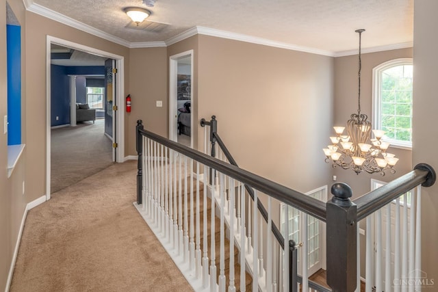 3773 Top Flite Ln, Mason, OH 45040 - hall featuring an upstairs landing, a chandelier, carpet flooring, plenty of natural light, and crown molding