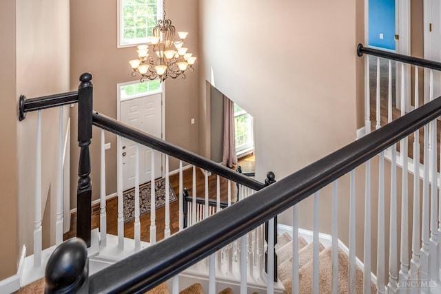 3773 Top Flite Ln, Mason, OH 45040 - staircase featuring plenty of natural light and a chandelier