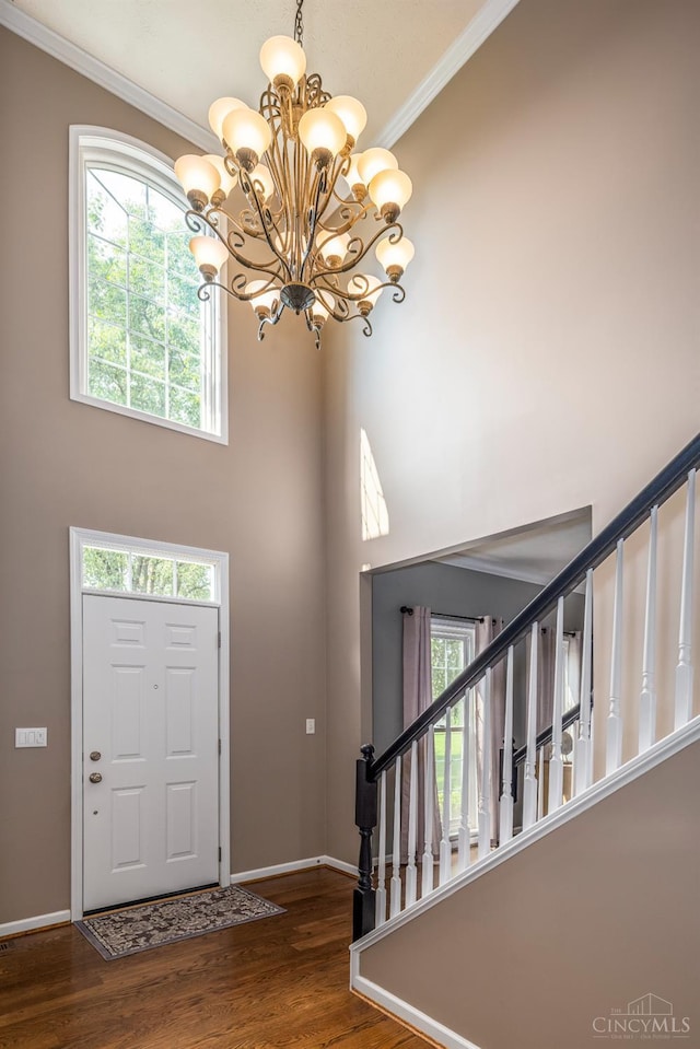 3773 Top Flite Ln, Mason, OH 45040 - foyer featuring a chandelier, wood finished floors, a high ceiling, and crown molding
