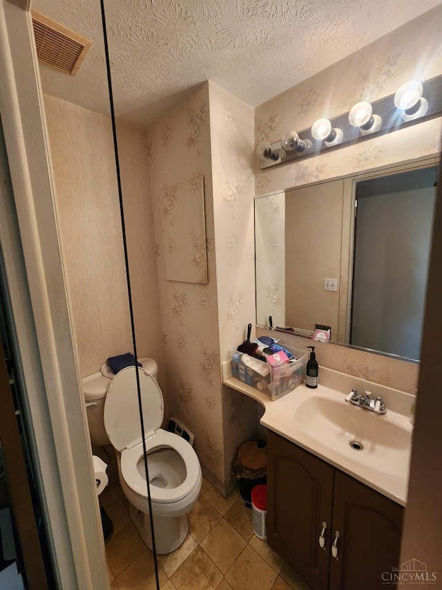 2920 Spruceway Dr, Colerain Twp, OH 45251 - bathroom featuring vanity, wallpapered walls, a textured ceiling, and tile patterned floors