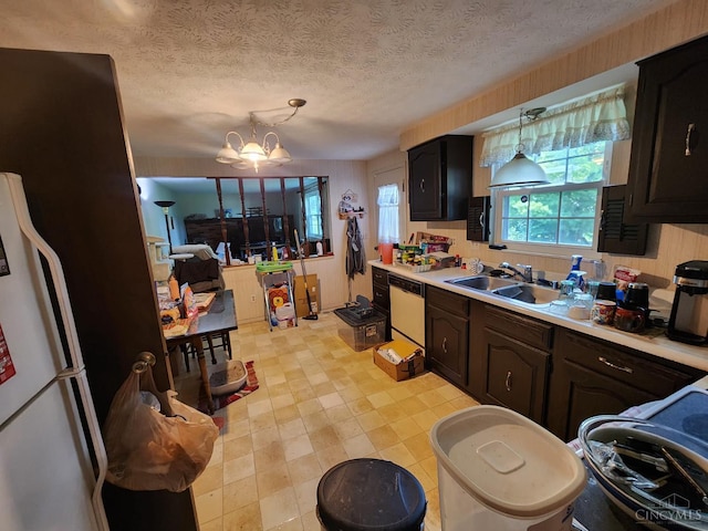 2920 Spruceway Dr, Colerain Twp, OH 45251 - kitchen featuring white appliances, light countertops, a chandelier, hanging light fixtures, and a textured ceiling