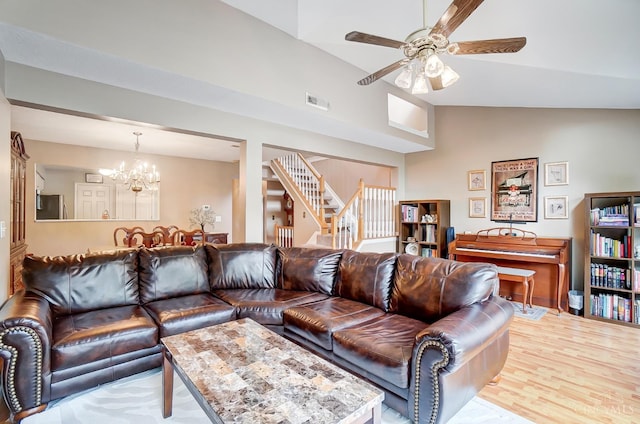 5788 Spire Ridge Ct Unit 13B, Green Twp, OH 45247 - living area featuring stairs, vaulted ceiling, a chandelier, a ceiling fan, and wood finished floors