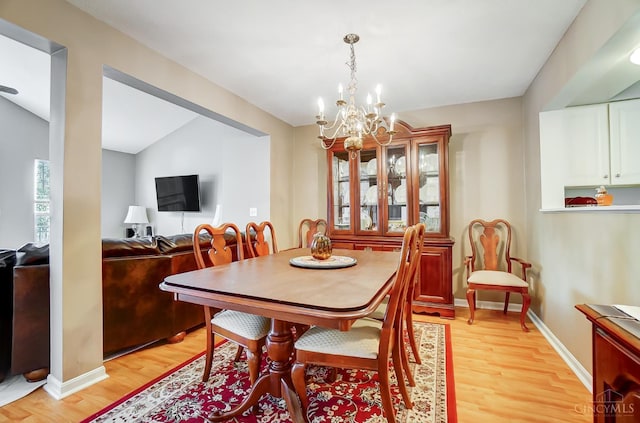 5788 Spire Ridge Ct Unit 13B, Green Twp, OH 45247 - dining space with light wood-style flooring and a chandelier