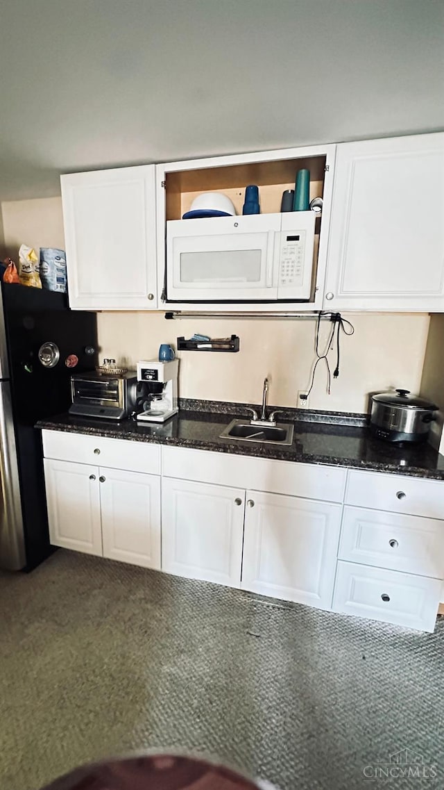 420 Lake Shore Dr, Lebanon, OH 45036 - kitchen featuring white microwave, white cabinets, and dark stone counters