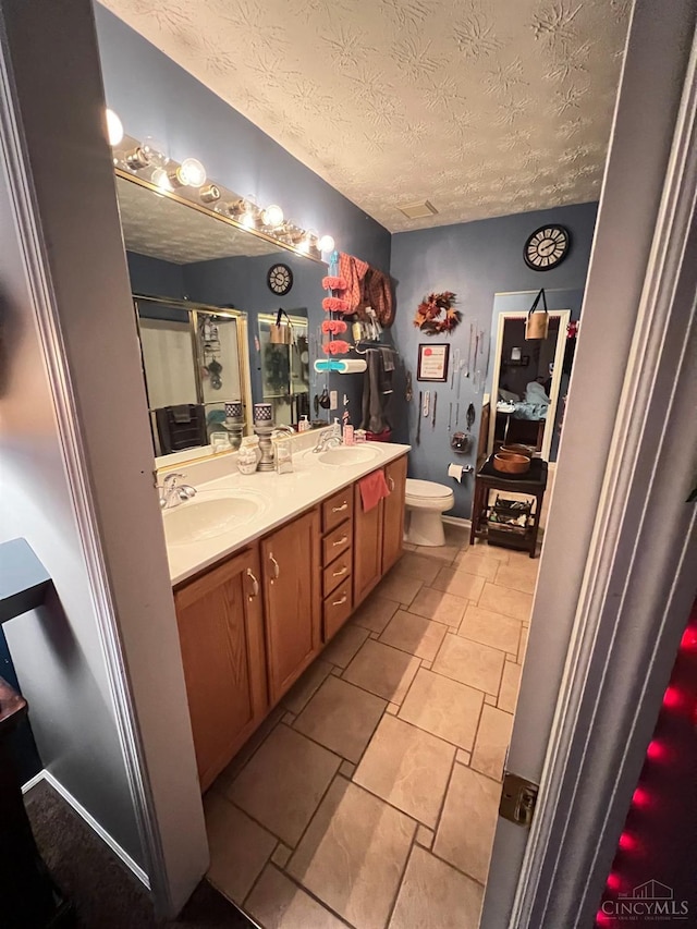 420 Lake Shore Dr, Lebanon, OH 45036 - full bath featuring a textured ceiling, double vanity, a stall shower, and tile patterned floors