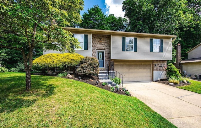 8798 Beckys Ridge Dr, Colerain Twp, OH 45251 - bi-level home featuring an attached garage, concrete driveway, brick siding, and a front yard