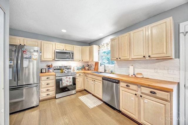 8798 Beckys Ridge Dr, Colerain Twp, OH 45251 - kitchen with appliances with stainless steel finishes, wooden counters, light wood finished floors, decorative backsplash, and recessed lighting