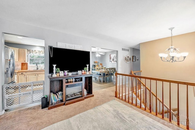 8798 Beckys Ridge Dr, Colerain Twp, OH 45251 - living room featuring a chandelier, a ceiling fan, and carpet flooring