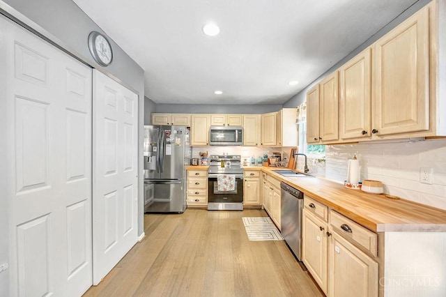 8798 Beckys Ridge Dr, Colerain Twp, OH 45251 - kitchen featuring appliances with stainless steel finishes, light brown cabinets, backsplash, light wood-style flooring, and recessed lighting