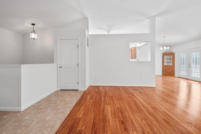 1583 Creekside Rd, Batavia Twp, OH 45102 - empty room with lofted ceiling, a chandelier, and wood finished floors