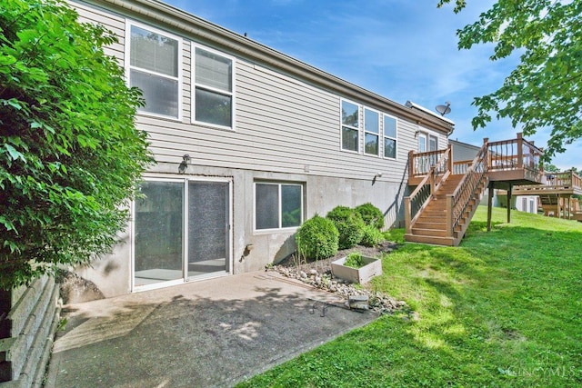 1583 Creekside Rd, Batavia Twp, OH 45102 - back of house with stairs, a lawn, a wooden deck, and a patio area
