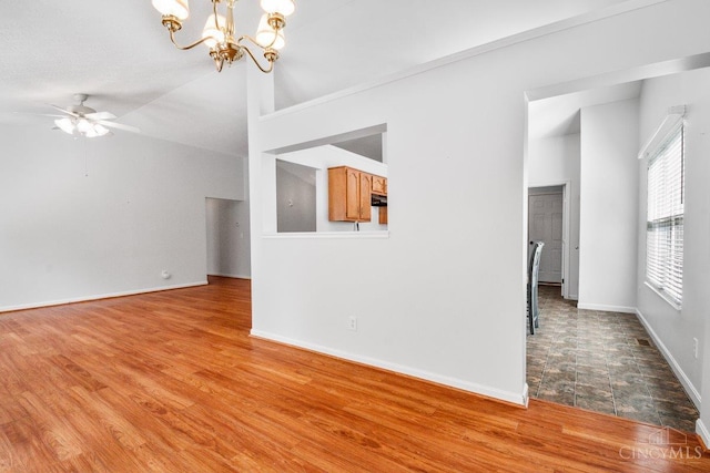 1583 Creekside Rd, Batavia Twp, OH 45102 - unfurnished living room with a chandelier, a ceiling fan, wood finished floors, and vaulted ceiling