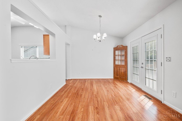 1583 Creekside Rd, Batavia Twp, OH 45102 - unfurnished dining area with wood finished floors, healthy amount of natural light, a chandelier, and french doors